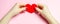 The girl holds a red heart in hands. Valentine`s day concept. Love and romance. Holiday. Minimalism. Romantic composition. Health