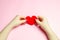 The girl holds a red heart in hands. Valentine`s day concept. Love and romance. Holiday. Minimalism. Romantic composition. Health