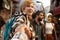 Girl holds someone hand and walking on crowded city street