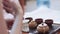 The girl holds a tea ceremony, teaches how to brew tea. On the table are cups, figurine and teapot