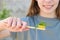 The girl holds a toothbrush with mint in her hand. Selective focus on the mint toothbrush