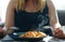 girl holds two forks over a plate with food for dinner