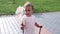 Girl holds a windmill in her hands and plays with it. Handheld shooting