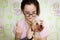 A girl holds a Yorkshire Terrier in her arms and feeds it cookies