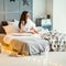 girl at home on Christmas cozy sitting on her bed in the interior