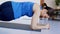 Girl at home exercises plank with twists and turns of the case.