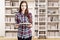 Girl in a home library with a ladder