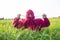 Girl with hood sitting on a meadow