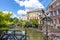 Girl on horse carousel monument and Utrecht canals in summer, Netherlands