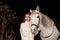 Girl and horse. Nice woman with white horse outdoors