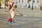 Girl in hot summer city with water sprinkler