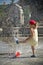 Girl in hot summer city with water sprinkler