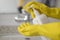 Girl hotel worker with cleaning products doing cleaning in the bathroom with a means for cleanliness