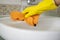 Girl hotel worker with cleaning products doing cleaning in the bathroom with a rag and a means for cleanlines