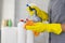 Girl hotel worker with cleaning products doing cleaning in the bathroom with a rag and a means for cleanliness