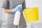 girl hotel worker with cleaning products doing cleaning in the bathroom with a rag and a means for cleanliness