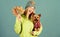 Girl hug cute dog and hold fallen leaves. Woman carry yorkshire terrier. Take care pet autumn. Veterinary medicine