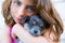 Girl hug a little puppy dog gray hairy chihuahua