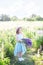 Girl with a huge bouquet of lupins in the field at sunrise. The concept of nature and romance. Happy childhood. Photo of summer wi