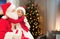 Girl hugging santa at home on christmas