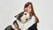 Girl hugging Siberian Husky dog in white studio