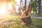 Girl hugs a beautiful young dog in a park on the background of a sunset. Embrace with the dog in the fresh air