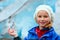 Girl with ice piece near Nigardsbreen glacier (Norway)