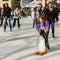 Girl Ice Skates with an Assist from a Toy Penguin