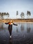 Girl ice skating on the ice of a forest lake