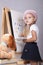 The girl in the image of the artist draws on the easel