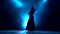 Girl in an incendiary dance of Argentine flamenco . Llight from behind. Smoke background. Silhouette