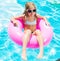 Girl on inflatable ring in swimming pool