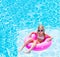 Girl on inflatable ring in swimming pool