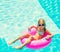 Girl on inflatable ring in swimming pool