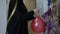 Girl inflates a balloon