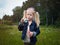 Girl inflates soap bubble. Portrait of a child.