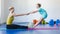 Girl and Instructor or mother doing gymnastic exercises in fitness class