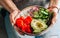 Girl in jeans holding hawaiian salmon poke bowl with seaweed, cucumber, avocado and sesame seeds.