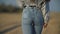 Girl in jeans walks along the road