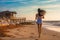 A girl jogging along the seaside. A healthy lifestyle and an effortless way of life. Generative AI