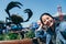 Girl joyfully taking selfie with huge crab sign