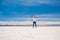 Girl in a jump in sunshine Salar de Uyuni