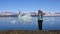 Girl jumping on the coast of the glacial lake Jokulsarlon