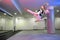 Girl jumping high in the air while practicing taekwondo