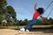 Girl jumping off swing