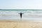 Girl jumping on the shore, Atlantic Ocean. Brittany, France.