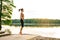 Girl jumping skipping rope on the lake