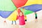 Girl jumping under tent during parachute games