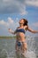 Girl jumping in water with splashes