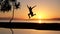 Girl jumping at the waterpool on the beach against the sunset